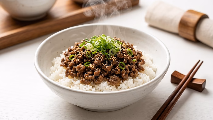 Korean ground beef rice bowl with sesame seeds and green onions
